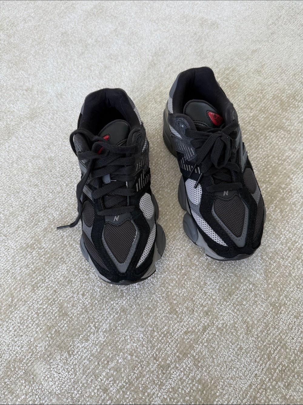 New Balance Black and Gray Trail Sneakers with Red Accent